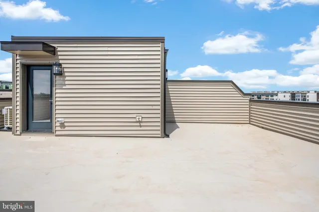 a view of a terrace that has white walls