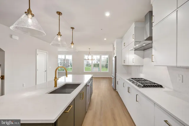 a kitchen with stove and cabinets