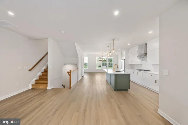a view of a kitchen with furniture and wooden floor
