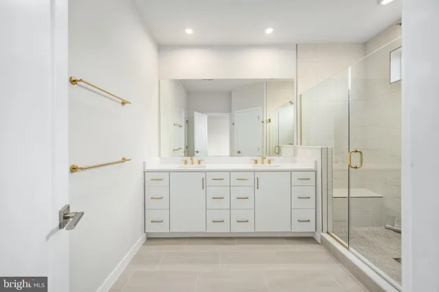 a spacious bathroom with a mirror a shower and a sink