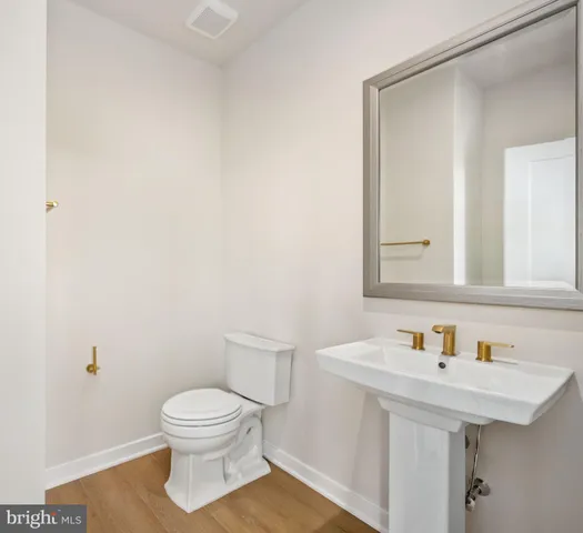 a bathroom with a sink toilet and mirror