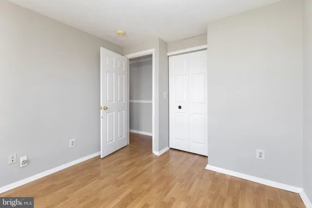 an empty room with wooden floor