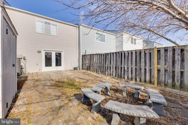 a backyard of a house with table and chairs