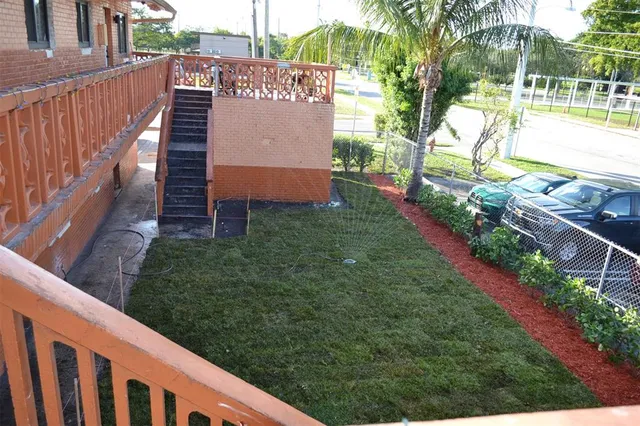 a view of a pathway of a house with a yard
