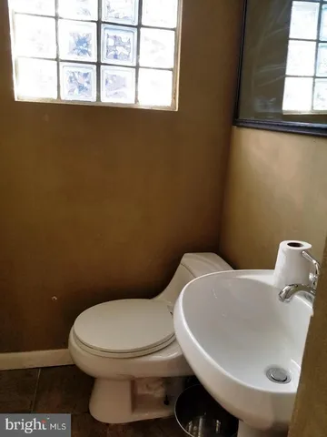 a white toilet sitting next to a bathroom sink
