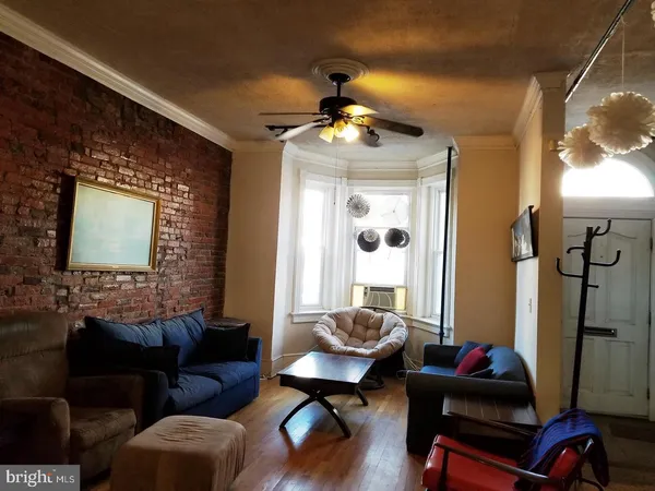 a living room with furniture and a mirror