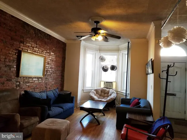 a living room with furniture and a mirror