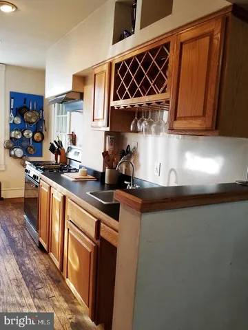 a kitchen with stainless steel appliances a sink stove and cabinets