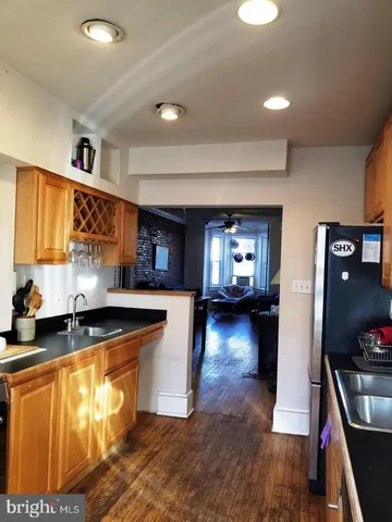 a kitchen with stainless steel appliances granite countertop a stove refrigerator and a sink