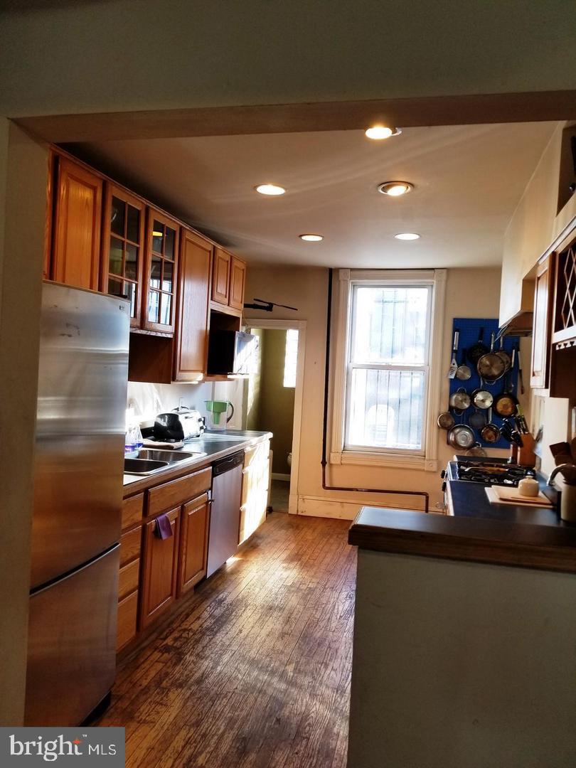 1377 F Street Northeast Washington, DC 20002 - Photo 6 of 13 a kitchen with stainless steel appliances granite countertop a sink stove and refrigerator