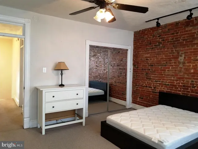 a bedroom with a bed and a desk