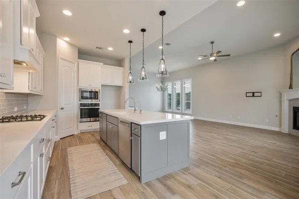 a large kitchen with stainless steel appliances lots of counter top space