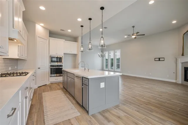 a large kitchen with stainless steel appliances lots of counter top space