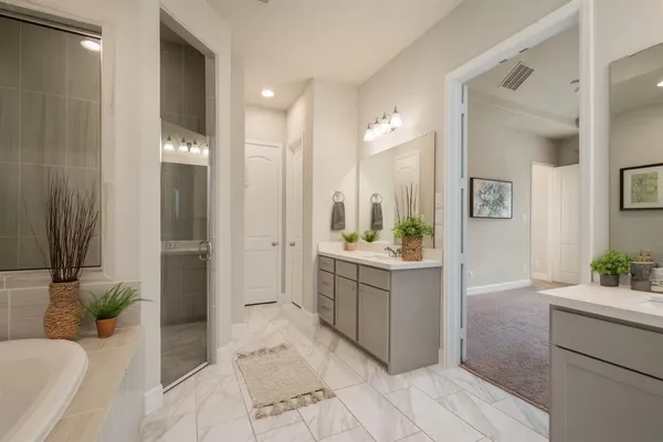 a bathroom with a tub sink and mirror