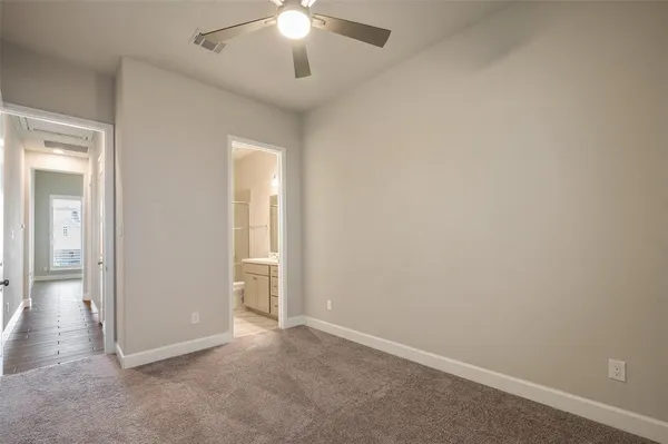 an empty room with chandelier fan