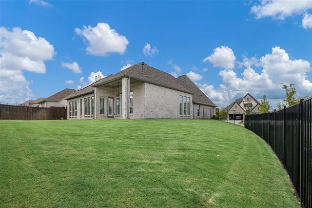 a yellow and red house with a garden