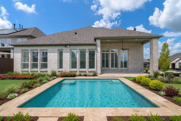 a view of a house with sitting area and garden