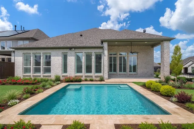 a view of a house with sitting area and garden
