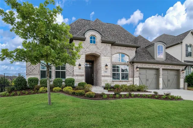 a front view of a house with a garden and plants