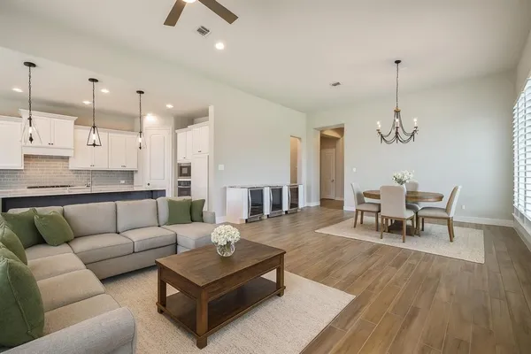 a living room with furniture and a chandelier