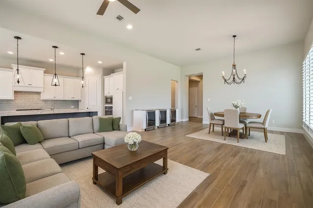 a living room with furniture and a chandelier