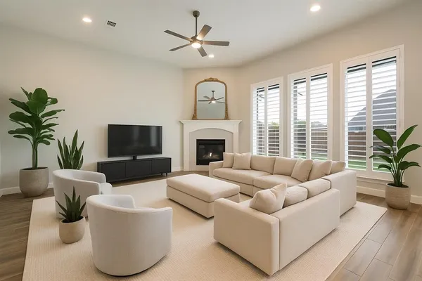 a living room with furniture a chandelier and a fireplace