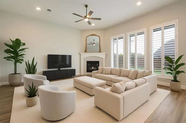 a living room with furniture a chandelier and a fireplace