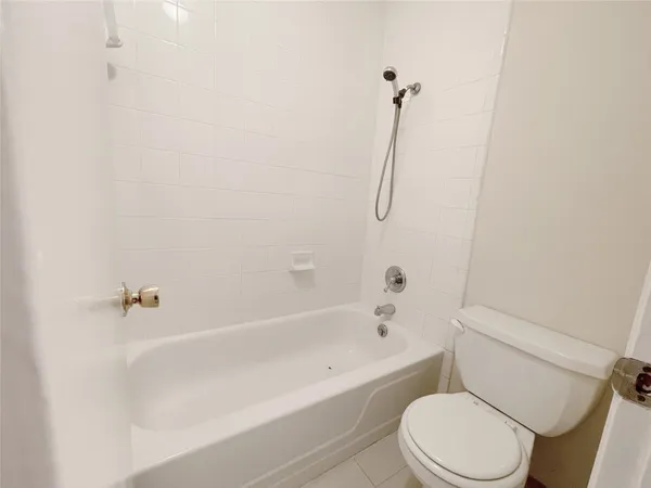 a bathroom with a toilet and a bath tub