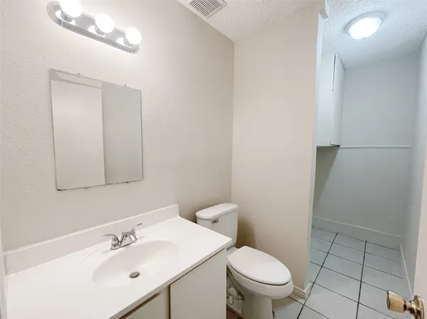 a bathroom with a sink a toilet and mirror