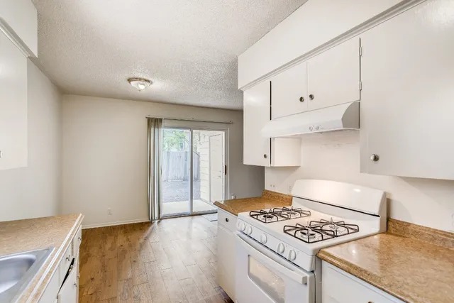 a kitchen with granite countertop a stove and a sink