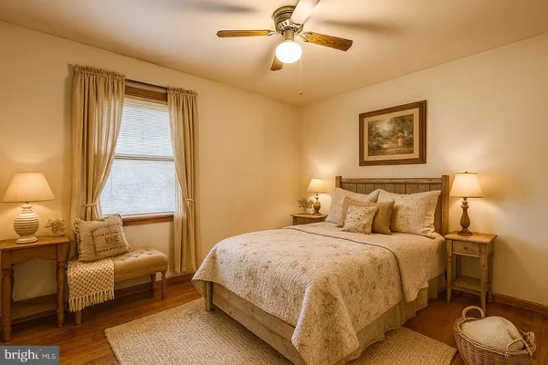 a view of a room with wooden floor and white walls