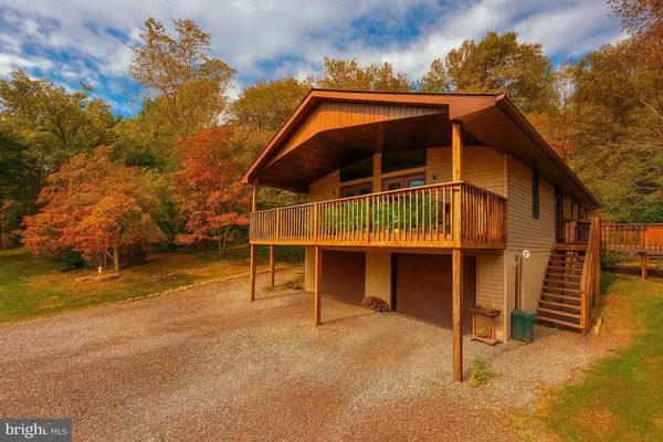 a balcony with wooden floor and outdoor seating