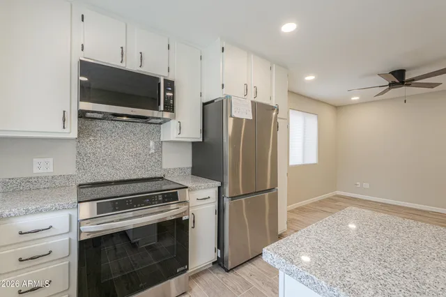 a view of a storage and utility room with washer and dryer