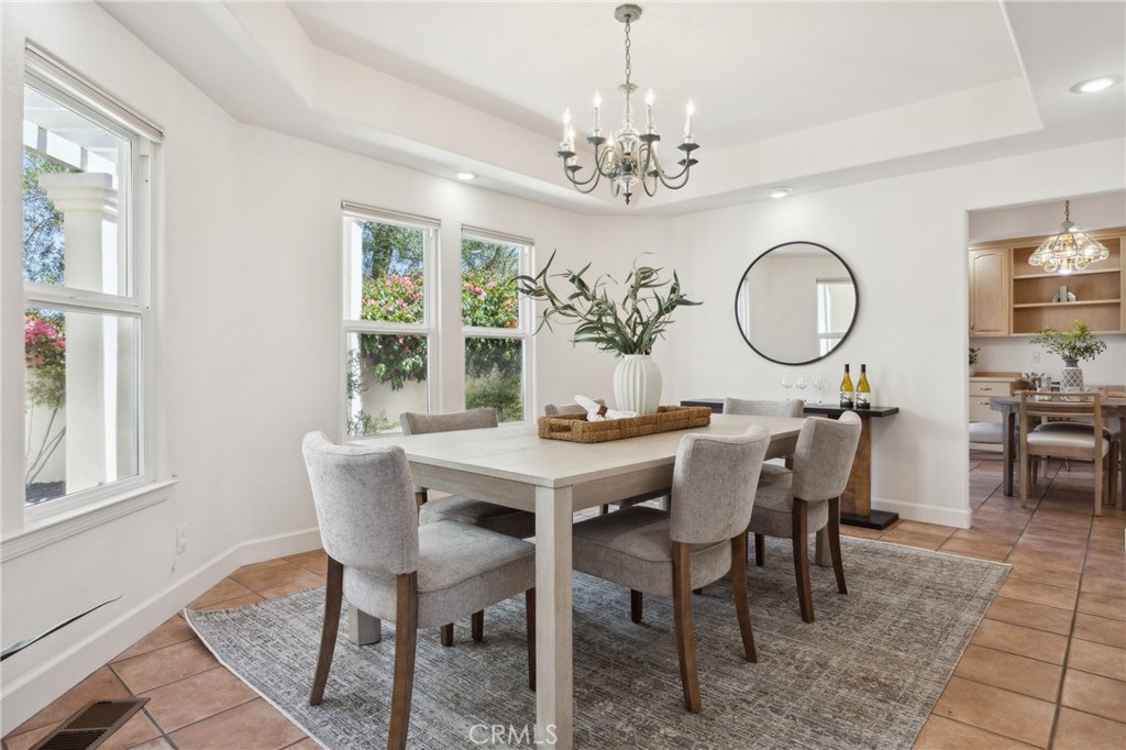 993 Las Palmas Way San Luis Obispo, CA 93401 - Photo 20 of 63 a view of a dining room with furniture a chandelier and wooden floor