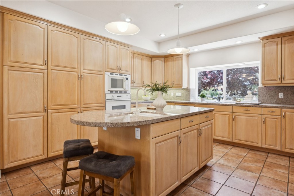 993 Las Palmas Way San Luis Obispo, CA 93401 - Photo 22 of 63 a kitchen with kitchen island granite countertop a sink appliances cabinets and furniture