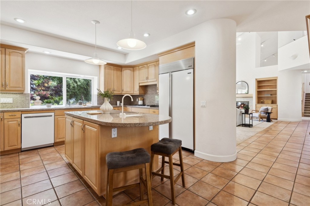 993 Las Palmas Way San Luis Obispo, CA 93401 - Photo 23 of 63 a kitchen with stainless steel appliances granite countertop a refrigerator a sink a stove and white cabinets with wooden floor