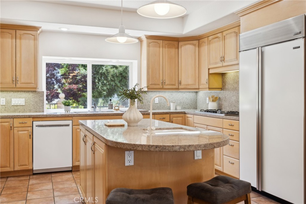 993 Las Palmas Way San Luis Obispo, CA 93401 - Photo 26 of 63 a kitchen with stainless steel appliances granite countertop a sink and a refrigerator