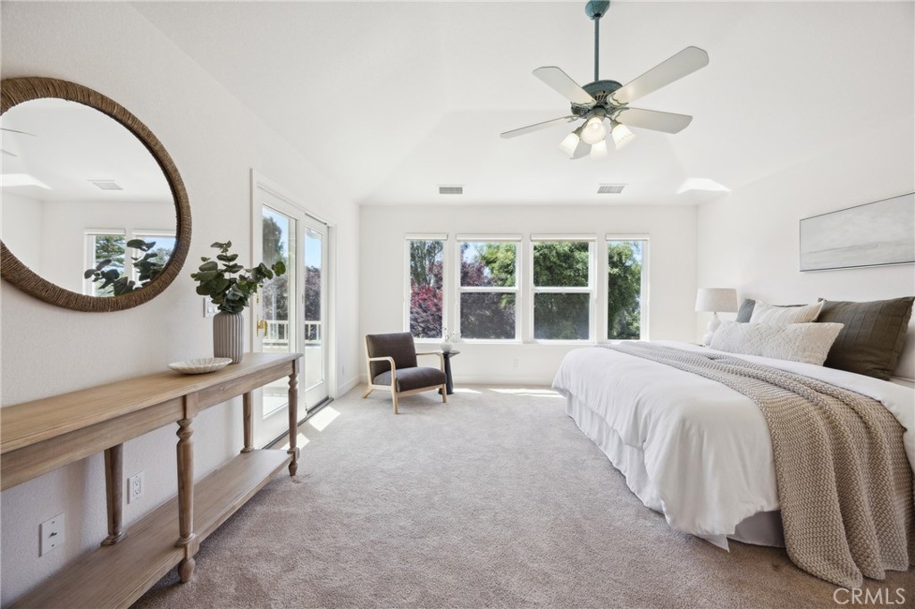 993 Las Palmas Way San Luis Obispo, CA 93401 - Photo 30 of 63 a spacious bedroom with a large bed and a chandelier
