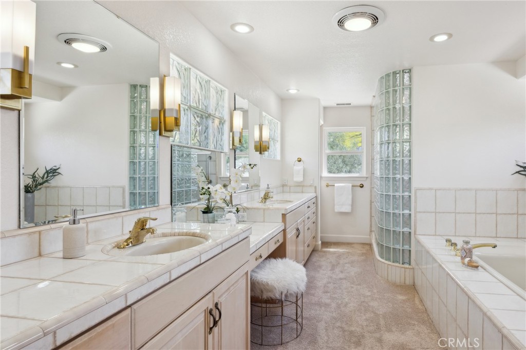 993 Las Palmas Way San Luis Obispo, CA 93401 - Photo 34 of 63 a spacious bathroom with a double vanity sink a toilet a mirror and shower