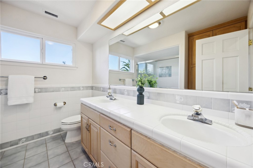993 Las Palmas Way San Luis Obispo, CA 93401 - Photo 43 of 63 a bathroom with a sink a toilet and mirror