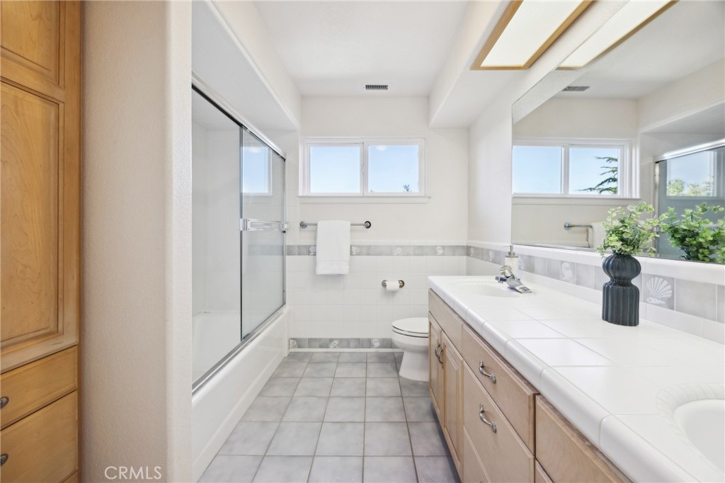 993 Las Palmas Way San Luis Obispo, CA 93401 - Photo 44 of 63 a spacious bathroom with a double vanity sink a mirror and a shower