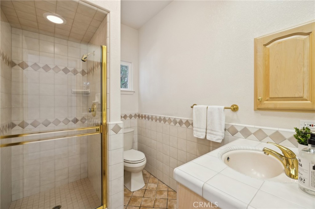 993 Las Palmas Way San Luis Obispo, CA 93401 - Photo 49 of 63 a bathroom with a granite countertop sink a toilet and shower