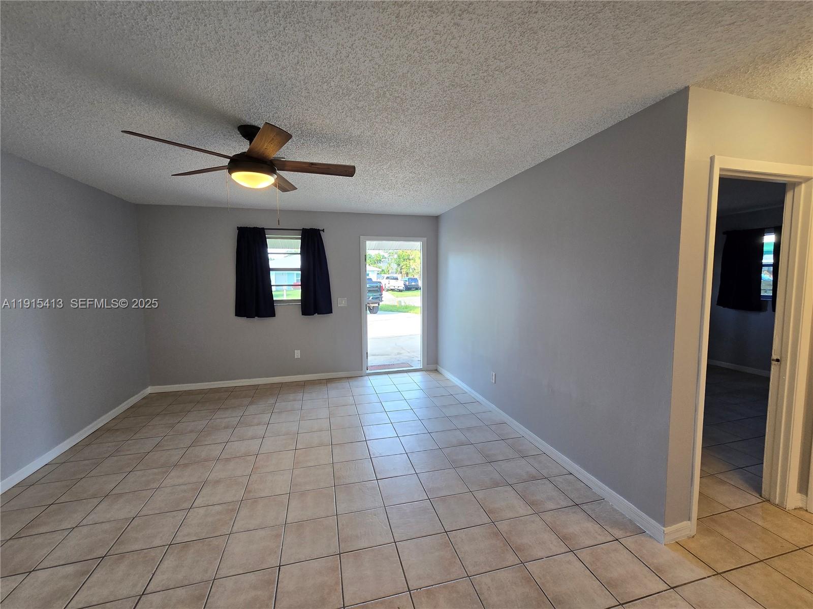 4550 Southeast Salvatori Road Stuart, FL 34997 - Photo 7 of 13 an empty room and chandelier fan in a room