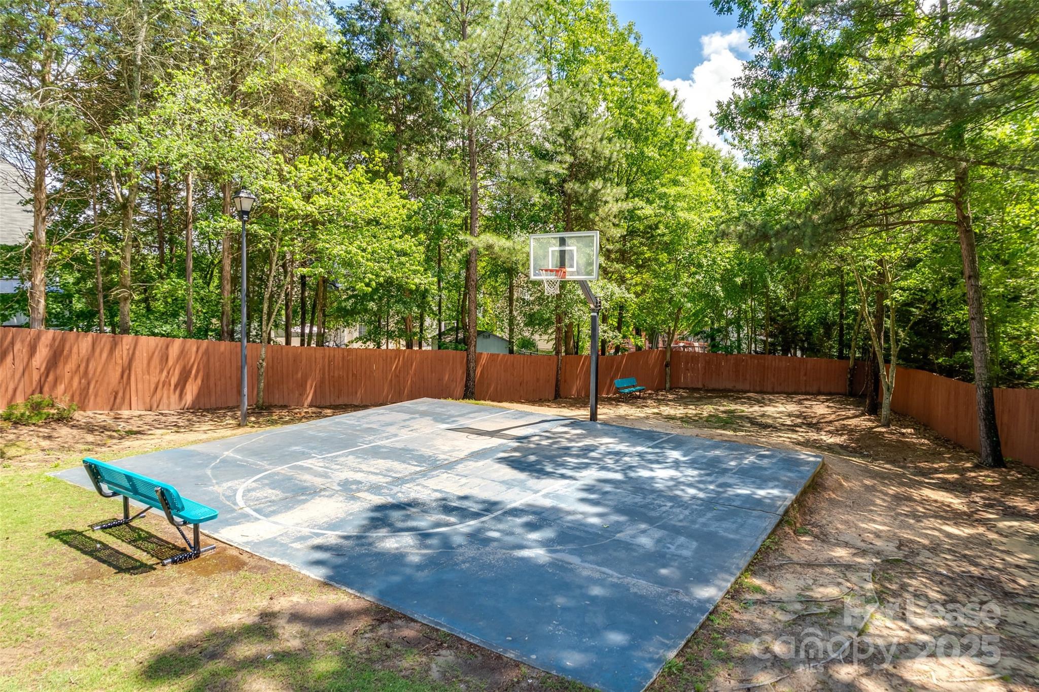 2535 Fossil Stone Lane Fort Mill, SC 29708 - Photo 42 of 43 a view of a backyard with wooden fence and a trees