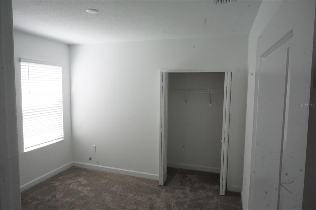 5704 Stephens Road, Unit 1 St. Cloud, FL 34771 - Photo 7 of 8 a view of an empty room with a window