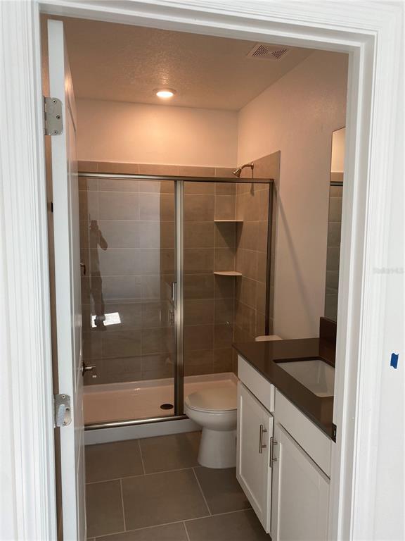 5704 Stephens Road, Unit 1 St. Cloud, FL 34771 - Photo 8 of 8 a bathroom with a granite countertop sink toilet and shower