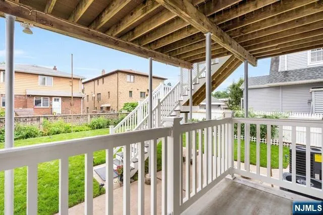 a view of a porch with a floor to ceiling window and wooden fence
