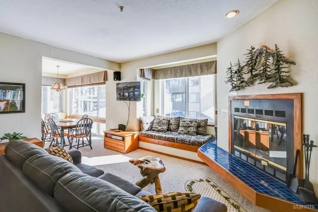 a living room with furniture fireplace and flat screen tv