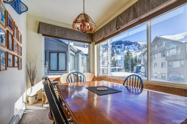 a view of a dining room with furniture wooden floor and chandelier