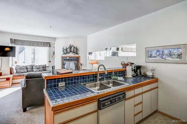 a kitchen with stainless steel appliances granite countertop a sink and cabinets
